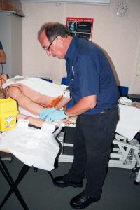  John Adamson demonstrates a cannulation technique to deliver intravenous fluids to a patient 