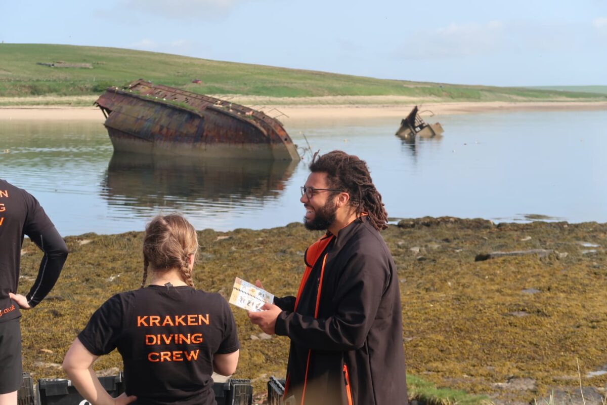 Samuel Thomsen stood by a semi-submerged shiwreck in Scapa flow