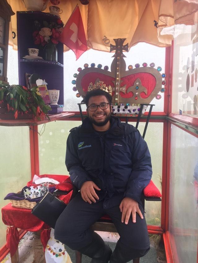 Samuel sitting on a throne in Unst bus stop